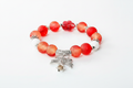 Bracelet perles rouges nœud papillon